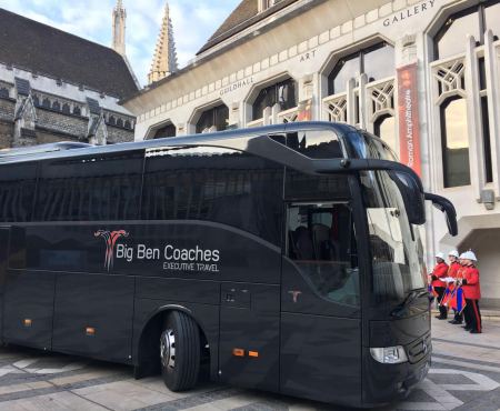 Black coach near historical building