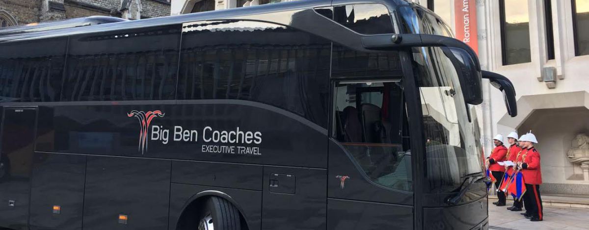 Black coach with uniformed guards