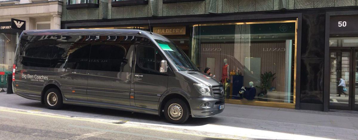 Gray coach parked outside store